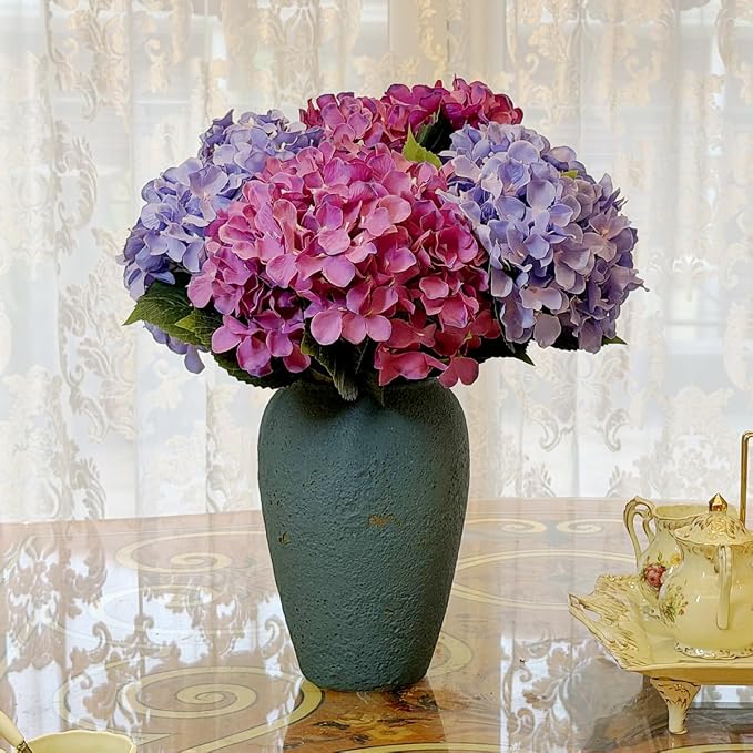 Pink artificial hydrangea arrangement in a garden urn for outdoor decor