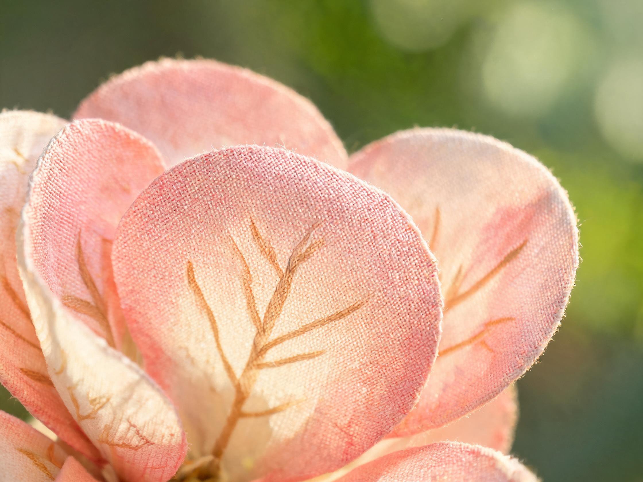 Macro detail of premium artificial flower petals showing eco-friendly recycled polyester materials with natural color gradients