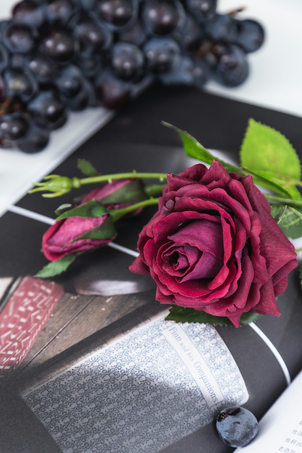 Close-up of a red artificial rose showing fabric petal texture and color detail