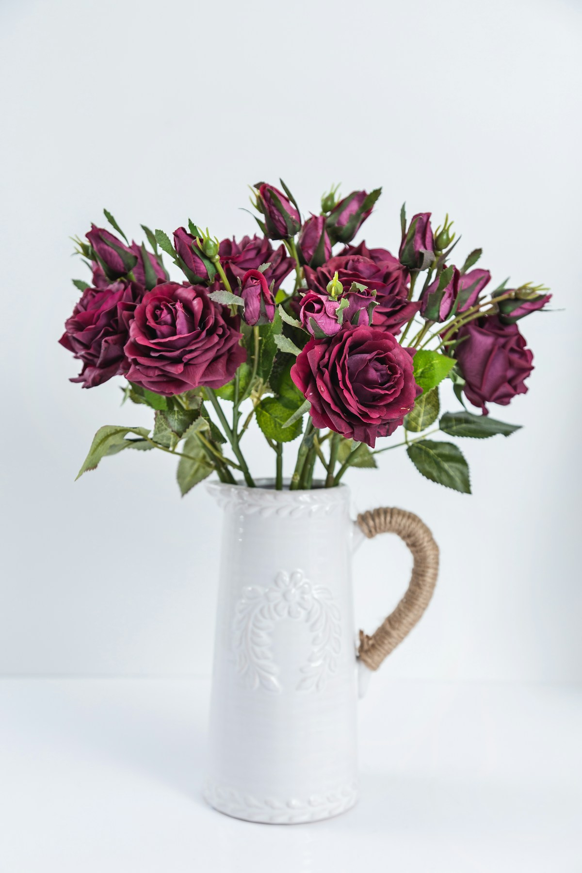 Purple artificial flowers arranged in a vase as a low-maintenance home decor display